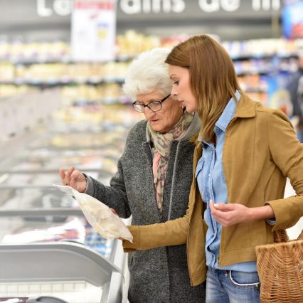 Elderly woman with young woman at the grocery store